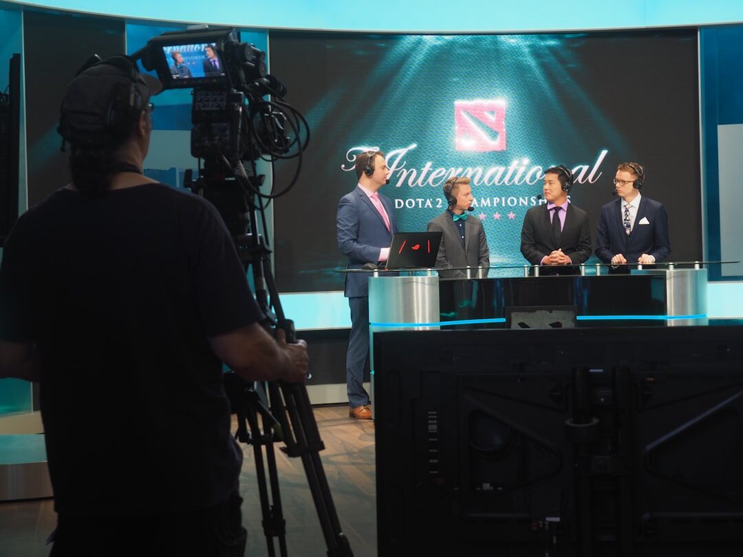Professional broadcast newsroom with multiple screens showing live news feeds
